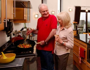 Image: Man an women cooking with natural gas in kitchen