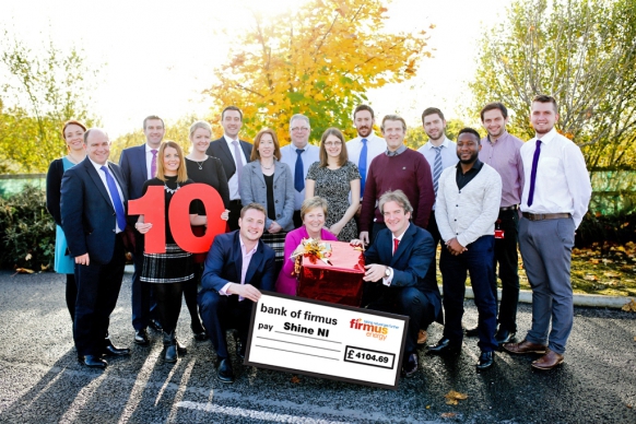 Image: staff from firmus energy presenting a cheque to Shine NI