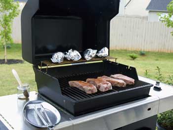 Image: cooking steaks with a natural gas bbq