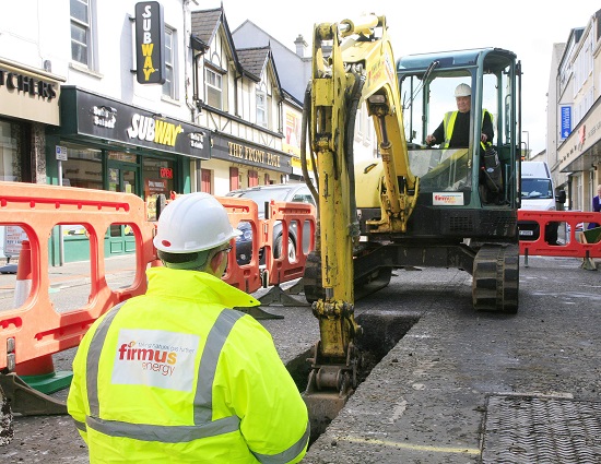 Excavating a road with a digger for natural gas installation