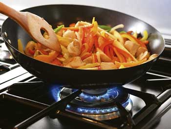 Image: wok cooking using natural gas cooker